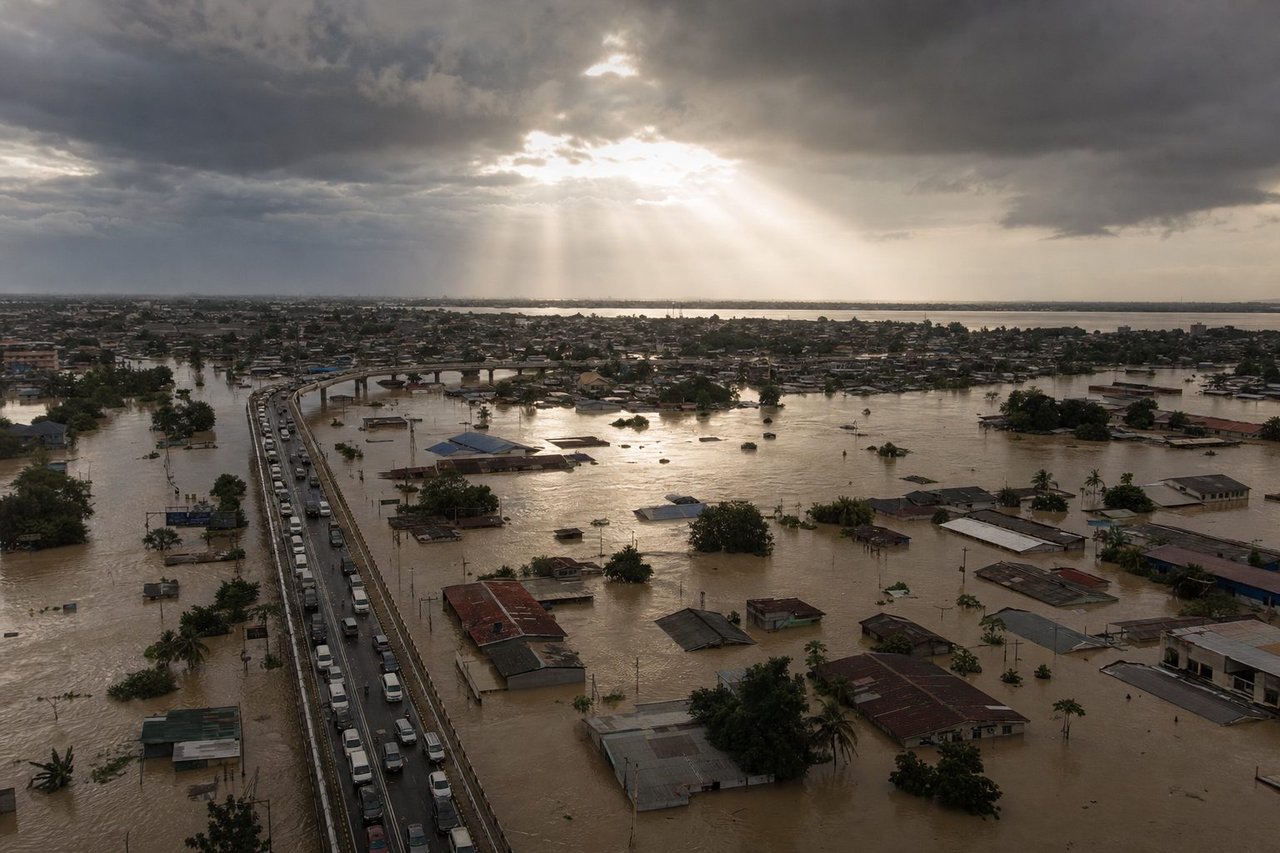 A dramatic aerial view of a flooded city district with submerged streets