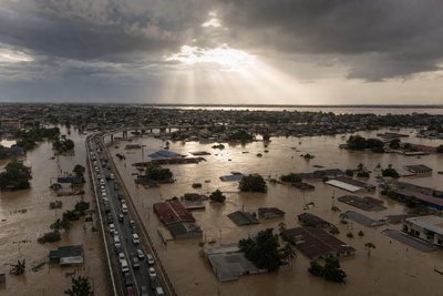 A dramatic aerial view of a flooded city district with submerged streets