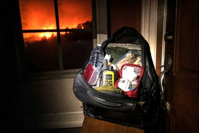 A packed emergency go-bag ready by a front door